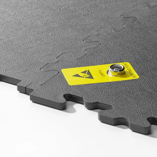 Photo showing the thickness of a studded ESD floor tile