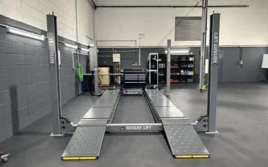 Stoneacre Motor Group commercial garage with dark grey ecotile floor tiles installed around vehicle ramps