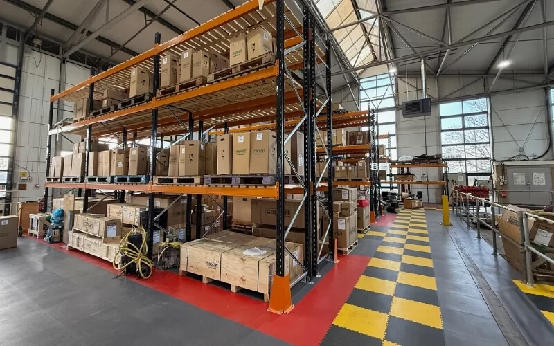 Bradfield Storage Handling racking in a warehouse surrounded by ecotile industrial flooring, with safe walkways and designated zones marked out by using different coloured interlocking floor tiles